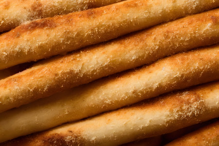 photo of breadsticks, crusty baked food item, high calorie snack