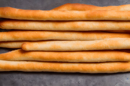 photo of breadsticks, crusty baked food item, high calorie snack