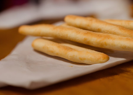photo of breadsticks, crusty baked food item, high calorie snack