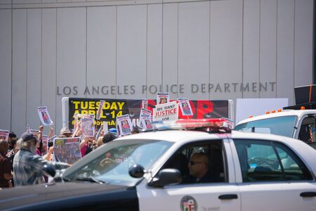 Los Angeles, CA, USA - April 14, 2015: Police observing people in front of Los Angeles Police Department during Stop Murder by Police. Protest against the brutalization and murdering of black and latino people by police for decades without consequence.のeditorial素材