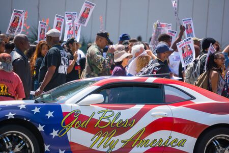 Los Angeles, CA, USA - April 14, 2015:  Car painted with american flag colors in front of protestors  during Stop Murder by Police. Protest against the brutalization and murdering of black and latino people by police for decades without consequence.のeditorial素材