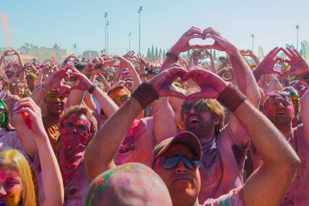 Norwalk, California, USA - March 7, 2015: People doing form of heart with his hands during the Holi Festival of Colorsのeditorial素材