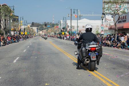 Los Angeles, California, USA - February 21, 2015 - Police officers on motorcycles performing at 116th Annual Golden Dragon Parade, celebrating the year of the ram in Chinatown Los Angeles.のeditorial素材