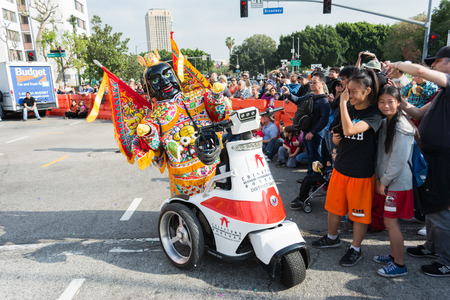 Los Angeles, California, USA - February 21, 2015 - An unidentified man with chinese costume and mask 116th Annual Golden Dragon Parade, celebrating the year of the ram in Chinatown Los Angeles.のeditorial素材