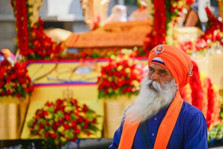 Los Angeles, CA, USA - April 5, 2015: Devotee Sikhs with orange turban marching at the Anniversary of Baisakhi celebration.のeditorial素材