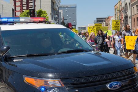 Los Angeles CA USA  May 02 2015: Police watching Protestants during march against the death of...