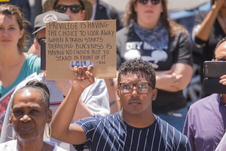 Los Angeles CA USA  May 02 2015: Man holding sign during march against the death of Freddie Gray a man of Baltimore who was seriously injured in police custody.のeditorial素材