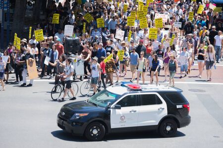Los Angeles CA USA  May 02 2015: Police watching Protestants in the streets with signs during march...
