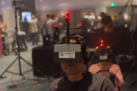 Los Angeles, CA - USA - August 29, 2015: Guy tries virtual glasses headset during VRLA Expo, virtual reality exposition, event at the Los Angeles Convention Center in Los Angeles.のeditorial素材