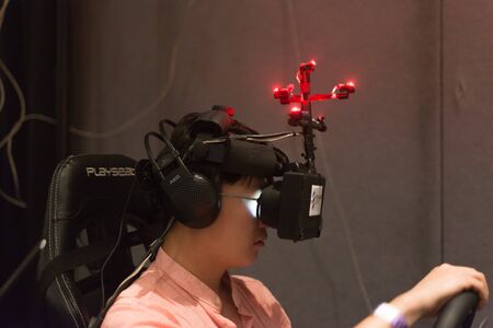 Los Angeles, CA - USA - August 29, 2015: Guy tries virtual glasses headset during VRLA Expo, virtual...