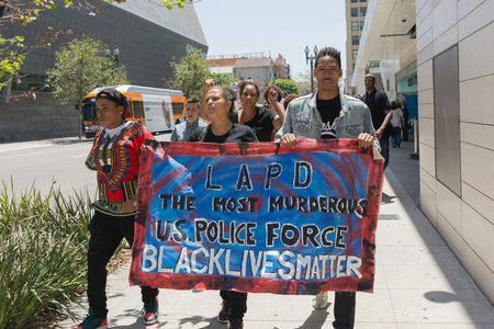 Los Angeles, USA - July 12, 2016 -  Black lives matter protestors holding a poster during march on City Hall following ruling on LAPD fatal shooting of African American female Redel Jonesのeditorial素材