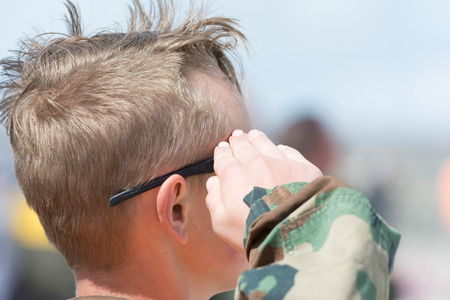 Lancaster, USA - March 25, 2017: Teen salute during National Anthem on display during Los Angeles County Air Show at the William J Fox Airfield.のeditorial素材