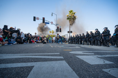 Los Angeles, USA â June 8, 2025: Riot police standing face to face with protester  during a downtown demonstration against expanded ICE operations and in support of immigrant rightsの写真素材