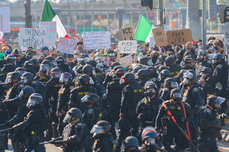 Los Angeles, USA â€“ June 8, 2025: Riot police face to face with protester during a downtown...