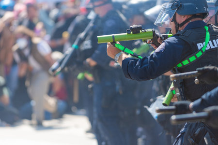 Los Angeles, USA â June 8, 2025: Los Angeles police officers in formation facing protesters during a downtown demonstration against expanded ICE operations and in support of immigrant rightsの写真素材
