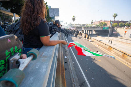 Los Angeles, USA â June 8, 2025: Protester holding Mexican flag during a downtown demonstration against expanded ICE operations and in support of immigrant rightsの写真素材