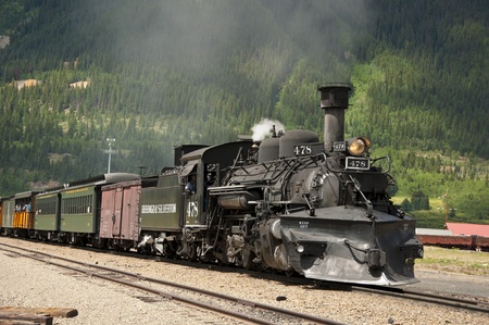 Old steam train coming into depotのeditorial素材