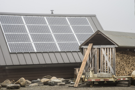 Solar panels and wood stack getting ready for winter.