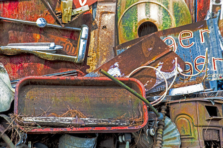 Old rusting metal pieces in a junkyard.の写真素材