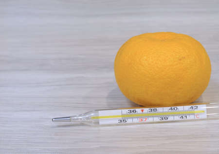Cold thermometer pills. Flu cure, remedy for convalescence. Photo on a wooden background.の写真素材