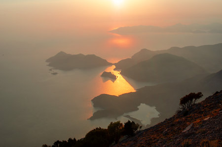 Paragliding from Babadag Mountain at Sunset overlooking Oludeniz near Fethiye in Turkey.の写真素材