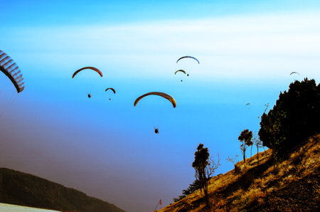 Paragliding from Babadag Mountain at Sunset overlooking Oludeniz near Fethiye in Turkey.