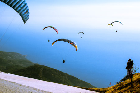 Paragliding from Babadag Mountain at Sunset overlooking Oludeniz near Fethiye in Turkey.の写真素材