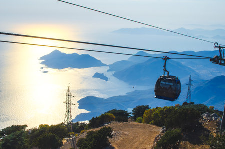 Amazing sunset time at Babadag. Teleferik cable cars are used to reach to peak of mountain. Fethiye,...