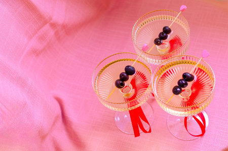 Valentines day pink coquette martini glasses with bow ribbons for bachelorette party invitation romantic dinner coquette.の写真素材