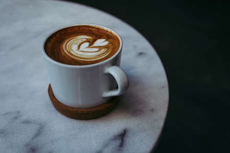 Latte or Cappuccino with frothy foam art, coffee cup top view on table  in coffee shop cafeの写真素材