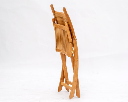 A wooden folding chair folded into itself isolated on a white backgroundの写真素材