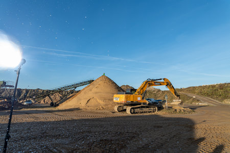 Excavator working on a sandpit at a construction site.の写真素材