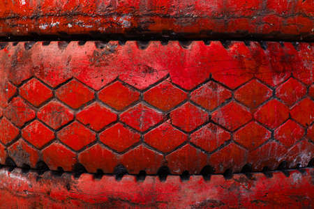 Motivation inscription on the big red old tire.