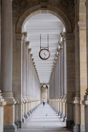 Old clock, and stone columns in Karlovy Vary, Czech Republic.のeditorial素材