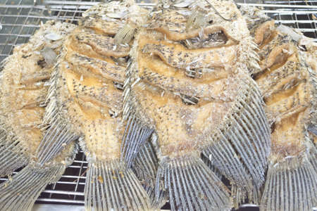 The fried fish on cooking rack