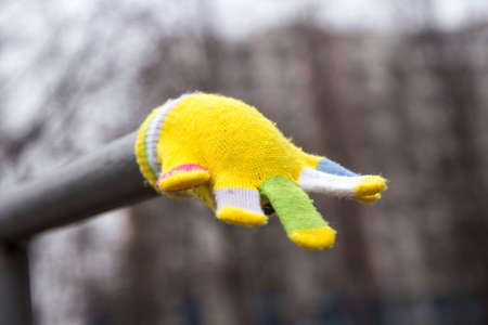 Lost childrens multi-colored wool glove awaits the ownerの写真素材