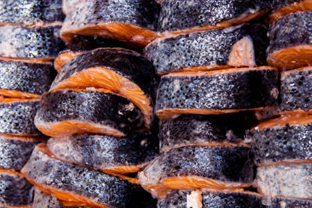 Close up slices of red fish on ice in a fish marketの写真素材