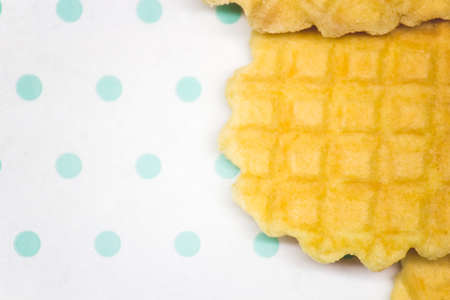 baked round waffles on a white turquoise background copy spaceの写真素材