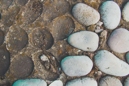 Pebbles on asphalt closeup stone with holes backgroundの写真素材