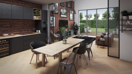 Industrial loft with a brick wall covered with paintings, parquet, a bay window overlooking a garden and modern furnitureの写真素材