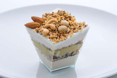 frozen yogurt cake with nuts in the cup nuts on the plateの写真素材