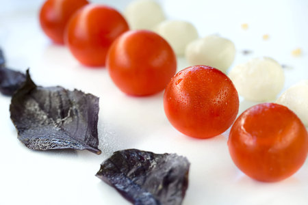 Tomatoes, mozzarella and basil are in lineの写真素材