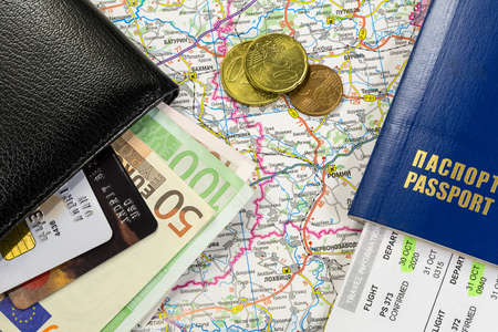 Travel kit. Close-up picture of a passport, wallet, money and mapの写真素材