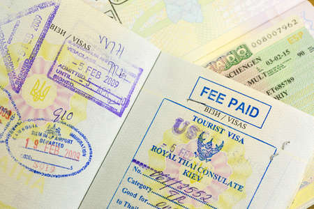 passports with cambodia, schengen and thailand visa stamps