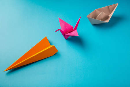 row of colored paper origami plane crane, boatの写真素材