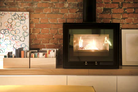 Fragment of interior loft. Burning fireplace. の写真素材
