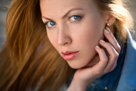 fashion portrait of strict red-haired girl, close up.の写真素材
