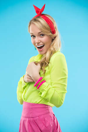 Emotional model in bright multi-colored clothes in surprise emotionally wrapped her arms around the personの写真素材