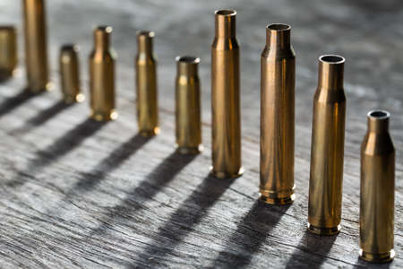 Number of different-sized sleeves hunted on a wooden textured background.の写真素材