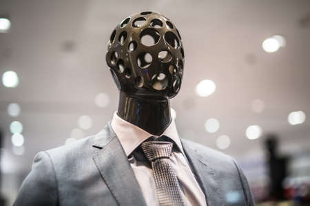 Stylish mannequin outside showcases a shopping center in male business suit and tieの写真素材